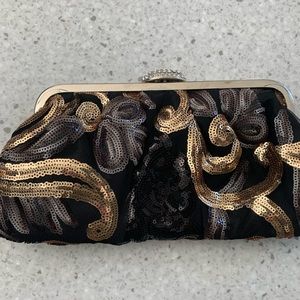 Used once. Excellent condition. Small dressy purse. Black, pewter and gold.